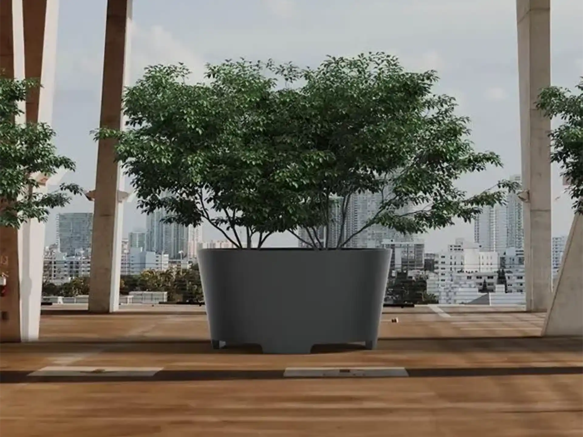 Grote Adezz Conic aluminium plantenbak met poten, gevuld met bomen, geplaatst op een modern dakterras met stadsuitzicht.