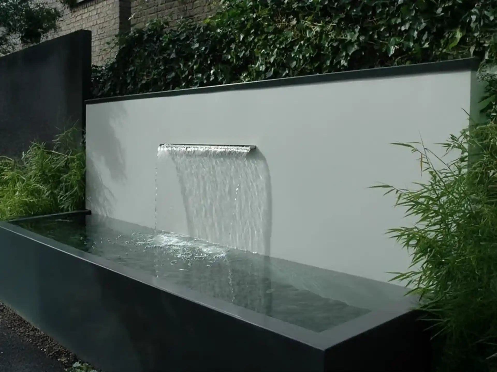 Adezz vijvermuur geplaatst op aluminium vijver, waterval met stromend water en ingebouwde pomp, strak tuinontwerp.