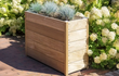 Adezz Carrez hardhouten plantenbak met bodem, beplant met siergrassen en vaste planten in een tuin.
